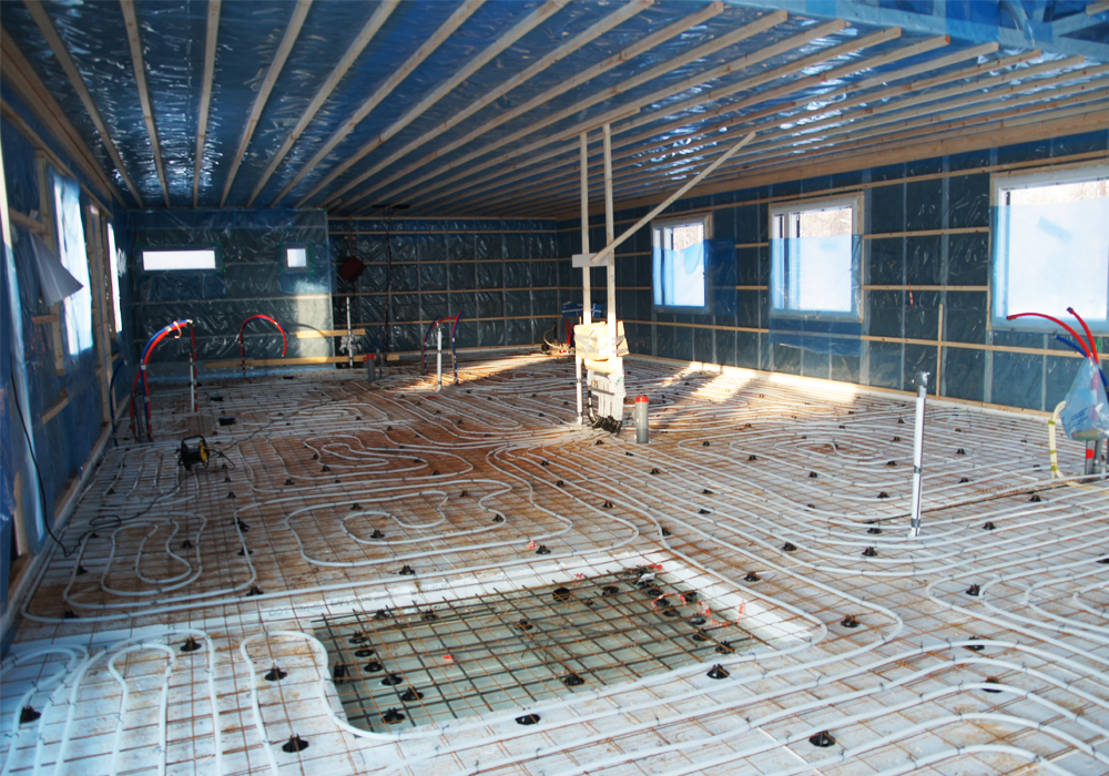 Omakotitalon rakentaminen, omakotialoon on asennettu lattialämmitysputkisto.